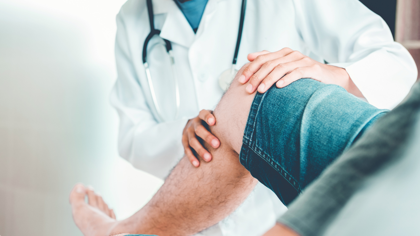 A doctor holding the leg of a patient